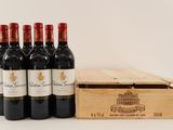 six bottles of red wine in a wooden box next to a bottle of wine