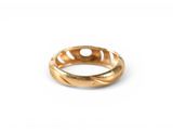 a close up of a gold ring on a white surface