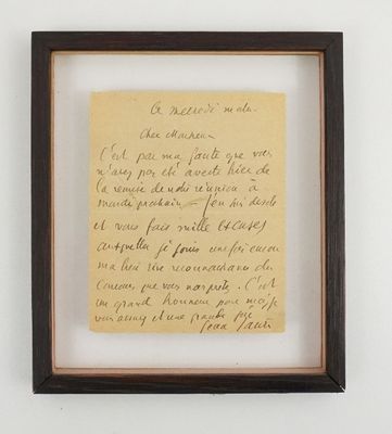 an old handwriting on a piece of paper hangs in a wooden frame