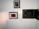a picture of a small room with pictures on the wall