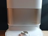 a white air purifier sitting on top of a wooden table
