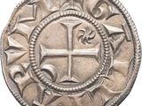 a close up of a coin with a cross on it