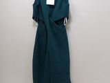 the dress is hanging on a hanger on the wall