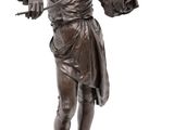 bronze statue of a man playing the violin on a marble base