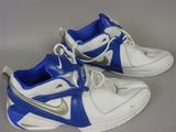 pair of white and blue sneakers with silver accents on a gray surface
