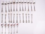 a lot of silver spoons and spoons on a table
