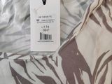 zebra print shirt with a tag on the back of it