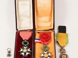 three medals and a medal in a case on a white surface
