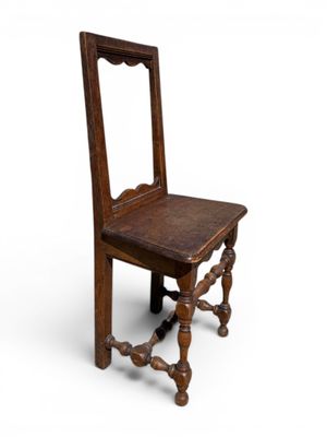 an old wooden chair with a mirror on the back of it