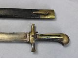 two different types of knives on a white surface