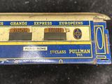 a small blue and yellow train car on a black surface