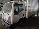 a white truck that is parked inside of a building