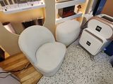 vue d'un salon avec un canapé, un fauteuil et une bibliothèque
