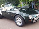 a green sports car parked on the side of the road