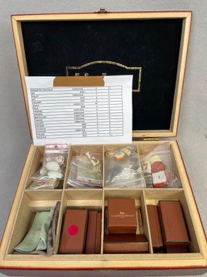a wooden box with a lot of items inside of it