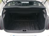 a trunk of a white car with the back door open