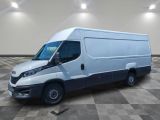 Une camionnette blanche est garée dans une grande pièce au sol carrelé.
