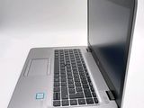 a silver laptop with a blue sticker on the screen