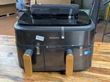 a black suitcase sitting on top of a wooden table