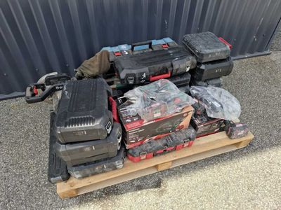 a pile of tools on a pallet in front of a building