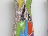 two vases that have been decorated with colorful designs on them