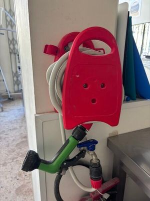 a red hose attached to a green and black hose