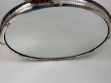 someone is holding a mirror in their hand on a white surface