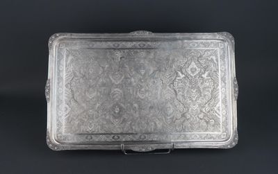 a silver tray with a floral design on it