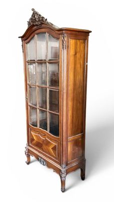 an antique display cabinet with a glass door and a wooden base