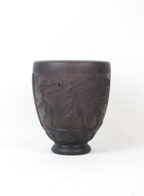 a brown bowl with a design on it