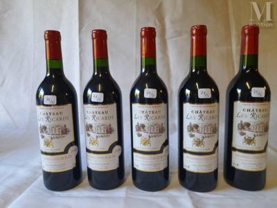four bottles of wine are lined up on a table