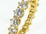 a close up of a diamond ring on a white surface