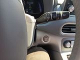 the interior of a car with a steering wheel and dashboard controls