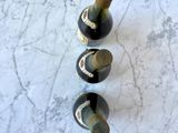 three wine bottles that are sitting on a marble table