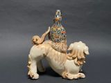 a figurine of a dog with a hat on its head