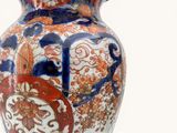 a vase with a design on it sitting on a table