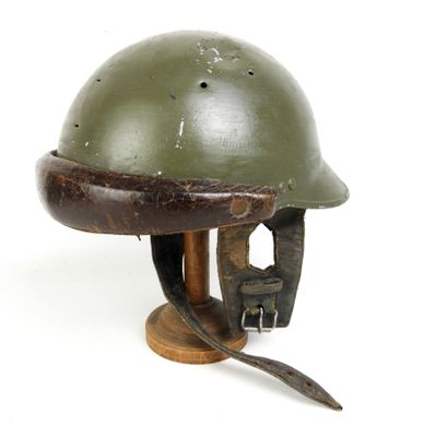 casque posé sur un support en bois, sur une surface blanche, avec un fond blanc
