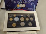 a box of coins sitting on a table next to a laptop
