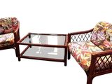 two wicker chairs and a coffee table on a white background