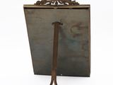 an antique mirror with a wooden handle and a metal stand