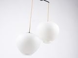 two white lamps hanging from the ceiling in the room
