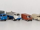 a row of toy trucks lined up on a white surface