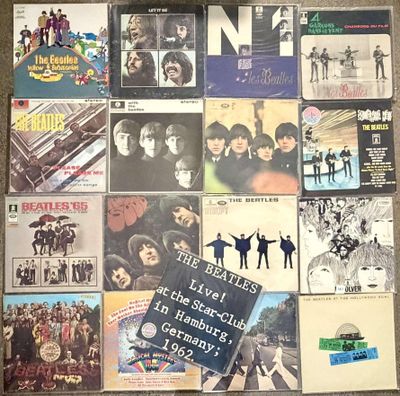 a lot of beatles album covers on the floor