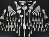 a lot of silver spoons and forks arranged in a circle