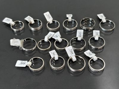 a lot of rings with tags on them on a table