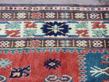 an image of a red and blue rug with a pattern on it