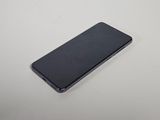 a close up of a cell phone on a white surface