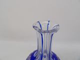a blue glass vase that is sitting on a table