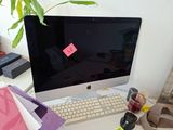 a computer monitor sitting on a desk next to a keyboard and mouse