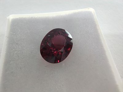 un gros plan d'un diamant rouge sur une surface blanche